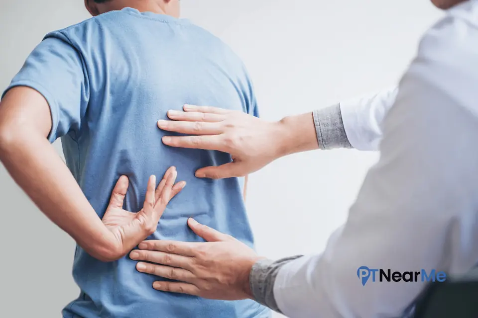 Physical therapist assessing post-accident lower back pain during an in-home visit in Florida.